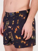 Bóxer de algodón blanco con estampado de flores pequeñas color celeste, con cintura elástica y logo de la marca en el centro.