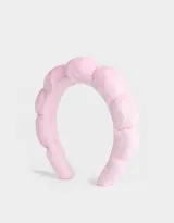 Vincha rígida color rosa con textura de peluche.