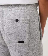 Pantalón de jogging gris oscuro con cintura elástica, cordón de ajuste, bolsillos delanteros y traseros, y tobillos ajustados.