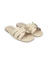 Sandalia chatita color beige con tiras anchas cruzadas en el empeine.