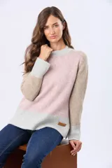 Buzo tejido de abrigo con bloques de color en rosa, beige y gris claro. Tiene cuello redondo y mangas largas.