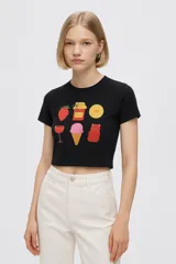 Remera blanca de algodón con cuello redondo y mangas cortas. Estampado con dibujos de comida.