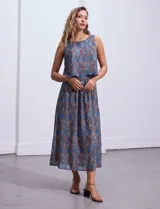 Vestido largo sin mangas de gasa estampada en tonos azules y marrones. Presenta escote redondo y corte en la cintura con punto smock.