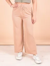 Pantalón palazzo beige de tejido acanalado con cintura alta y cordón ajustable.