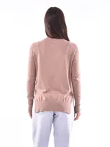 Sweater negro de tejido de punto fino, con cuello redondo y mangas largas con detalle de botones dorados en los puños.