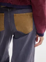 Pantalón de denim color marrón claro, de tiro alto, corte amplio y pinzas en la cintura.