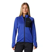 Campera polar azul con paneles negros en los hombros y el pecho, cierre frontal completo, cuello alto, mangas largas con orificios para los pulgares y bolsillos laterales con cierre.