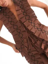Top marrón de lino con apliques de lino plisado y bordado con hilo negro en forma de rombos. Se ata en la parte delantera con cintas del mismo material.