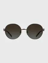 Lentes de sol de metal con forma redonda y lentes degradados en tonos marrones/kaki. La montura es de color bronce oscuro, con un detalle de eslabón ovalado decorativo en la unión del frente con las varillas. Las puntas de las varillas son de acetato en tono traslúcido.