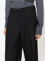 Pantalón sastrero negro de pierna ancha con pinzas en el delantero y cinturón con hebilla forrada.