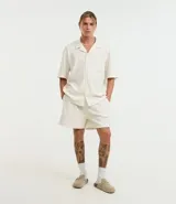 Bermuda masculina color crudo confeccionada en jacquard texturizado. Posee cintura elástica con cordón ajustable y bolsillos laterales.