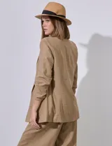 Blazer blanco de lino con cuello con solapa, bolsillos sastre y mangas fruncidas.