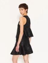 Chaleco negro con escote en V y cierre frontal con botones.