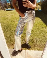 Pantalón slouchy de cuero ovino color plateado, corte mom fit con tiro semi alto y tajos inferiores.