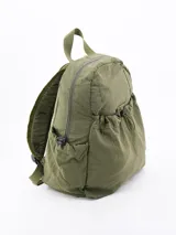 Mochila de tela color crema con bolsillo frontal con cordón ajustable, bolsillos laterales y correas de tela.