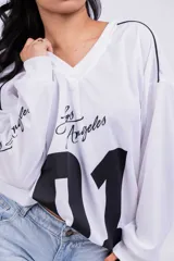 Remerón negro de corte holgado con estampado frontal del número 01 en blanco y la frase "Los Angeles" en las mangas.