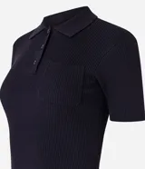 Blusa gris de punto acanalado con cuello polo, manga corta, botones en el cuello y bolsillo en el pecho.