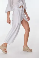 Conjunto de camisa celeste de mangas largas abullonadas y falda turquesa con detalle fruncido y lazo en el lateral.