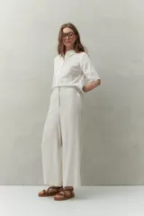 Pantalón palazzo color crema, de tiro medio con cintura elastizada en la parte posterior. Confeccionado en mezcla de lino y viscosa.