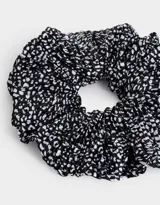 Maxi scrunchie de tela plisada con estampado animal print en blanco y negro.