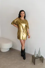 Remerón dorado con textura brillante y mangas cortas.