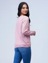 Buzo de hilado fino color rosa con detalle bordado y calado en la parte delantera, de manga larga.