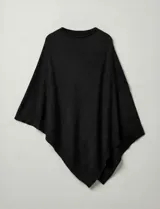 Poncho tejido de punto grueso, color mostaza/mostaza oscuro, con cuello redondo y caída amplia.