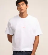 Remera masculina de corte boxy color blanco, con cuello redondo y mangas cortas. Presenta estampa lettering en el frente y photoprint en alto relieve en la espalda.