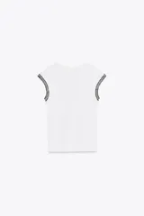 Camiseta negra de cuello redondo y sisa con detalle de fornitura con hilo metalizado a contraste en las mangas.