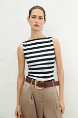 Camiseta sin mangas a rayas horizontales blancas y negras, con cuello barco y corte ajustado.