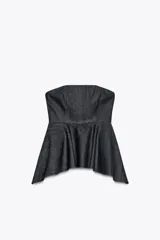 Top strapless de denim color azul oscuro, con corte recto y bajo asimétrico. Cierre con cremallera oculta en la costura.
