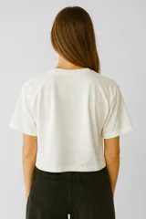 Remera manga corta color rosa con estampado de texto en el frente, de corte holgado y cuello redondo.