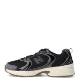 Championes New Balance 530 unisex, color negro con detalles en gris y blanco crema. Presentan una capellada de malla transpirable con refuerzos sintéticos y entresuela con tecnología ABZORB.