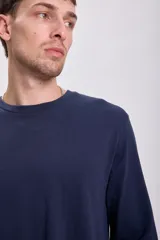 Remera de manga larga azul marino con cuello redondo y corte clásico.