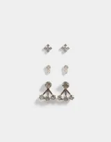 Set de tres pares de aros pasantes bañados en plata: un par con forma de alfiler, un par con forma de cruz y un par tipo earjacket con diseño de rosa y strass.