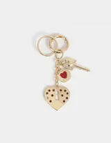 Llavero dorado con dije de corazón con cerradura y llave.