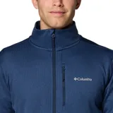 Campera polar Columbia Park View Fleece, color azul jaspeado, con cierre frontal completo, cuello alto, bolsillos laterales con cierre y bolsillo en el pecho con cierre vertical en color verde lima. Cuenta con tecnología Omni-Wick, puños elásticos con orificios para pulgares y protector de barbilla.