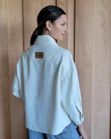 Sobrecamisa de pana fino beige, con botones ocultos y diseño versátil para usar cerrada o abierta.