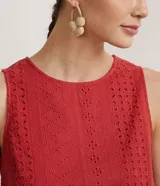 Blusa musculosa color ladrillo en tejido de laise texturizado, con cuello redondo, tirantes anchos y aplicación de canutillos de madera en la barra.