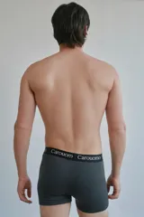 Boxer gris oscuro de microfibra lisa con elástico negro personalizado con el logo de la marca en blanco.