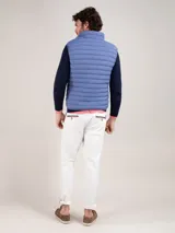 Chaleco gris acolchado para hombre, confeccionado en nylon reciclado repelente al agua, con cierre de cremallera, sisa elástica y logo engomado en el pecho.