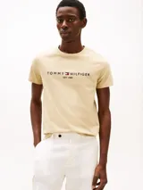 Remera color beige de algodón con cuello redondo y logo bordado de Tommy Hilfiger en el pecho.