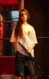 Remera blanca de corte holgado con un pequeño estampado amarillo en el pecho, inspirado en la película Kill Bill.