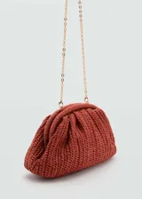 Bolso de mano tipo clutch color beige, tejido en fibra natural. Tiene asa larga desmontable para usar como bandolera, cierre a presión y forro interior.