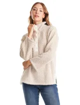 Buzo de tejido estampado en zigzag beige y blanco, con escote amplio, botones a presión en el cuello y mangas largas. Presenta botones a presión decorativos en los laterales.