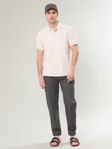 Polo de color rosa claro, de corte estándar con cuello y botones.