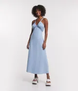 Vestido midi celeste confeccionado en jeans, con tirantes finos, escote en V, lazo en la espalda y detalle cutout.