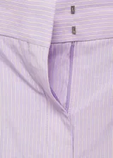 Pantalón wideleg color lila a rayas verticales, con trabillas, bolsillos laterales y traseros. Cierre oculto con botón, gancho y cremallera.
