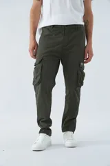 Pantalón cargo color marrón, corte slim, con cierre y botón en la cintura, pasacintos y bolsillos cargo con botones.