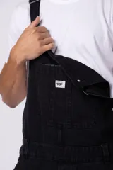 Jardinero de jean negro con breteles regulables y calce relaxed.